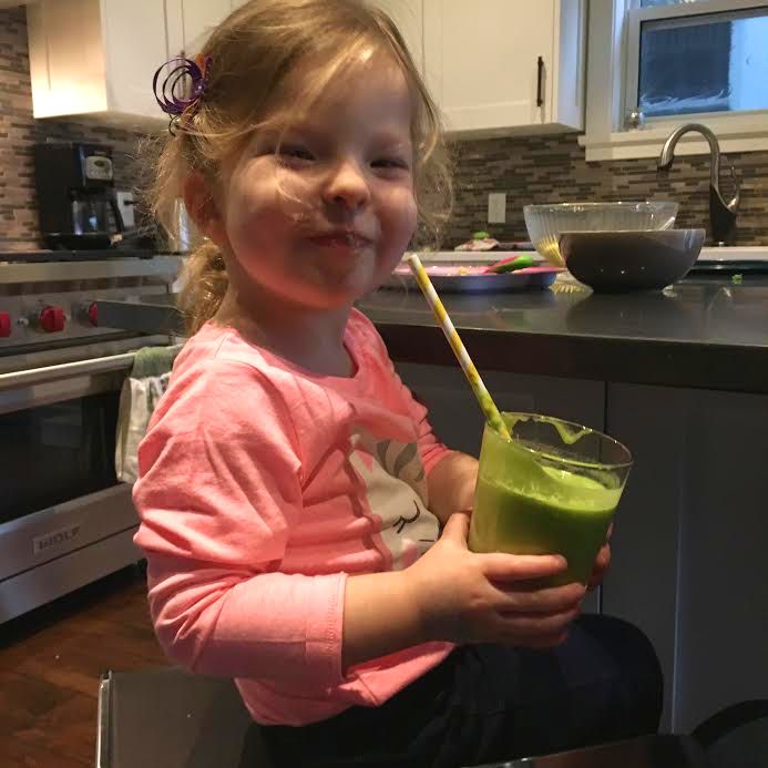 Miss Q is all smiles about her green smoothie